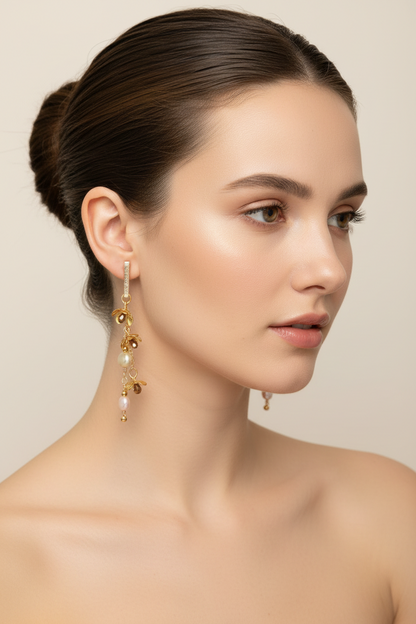 woman wearing handcrafted pearl and gold botanical dangle earrings