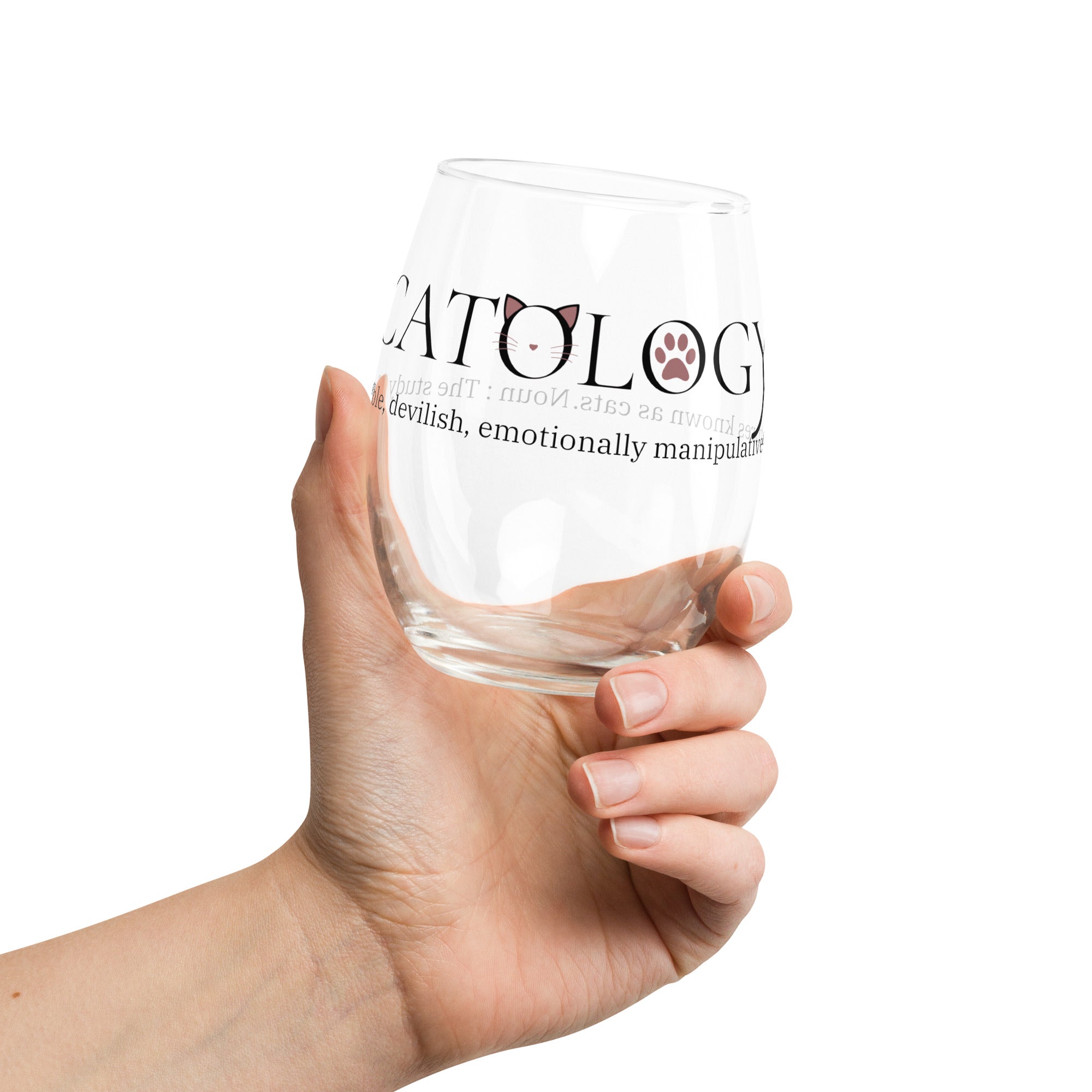 Hand holding clear Catology wine glass with cat-themed text
