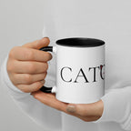 Person holding Catology mug with black handle, logo visible

